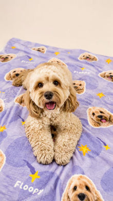 Custom pet blanket shown with a small dog sitting on a lavender star pattern
